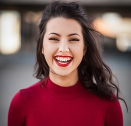 A photo of a beautiful foreign woman in a burgundy colored shirt